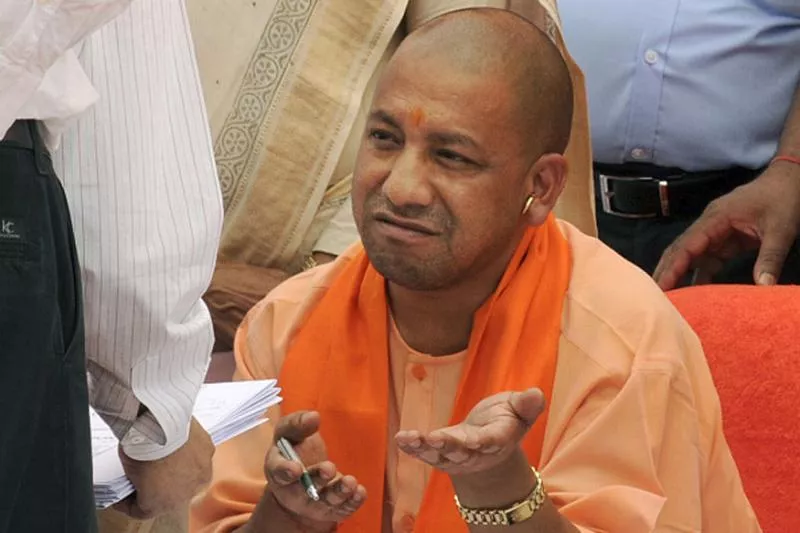 UP CM Yogi Refuse To Wear Cap At Kabir Mausoleum - Sakshi