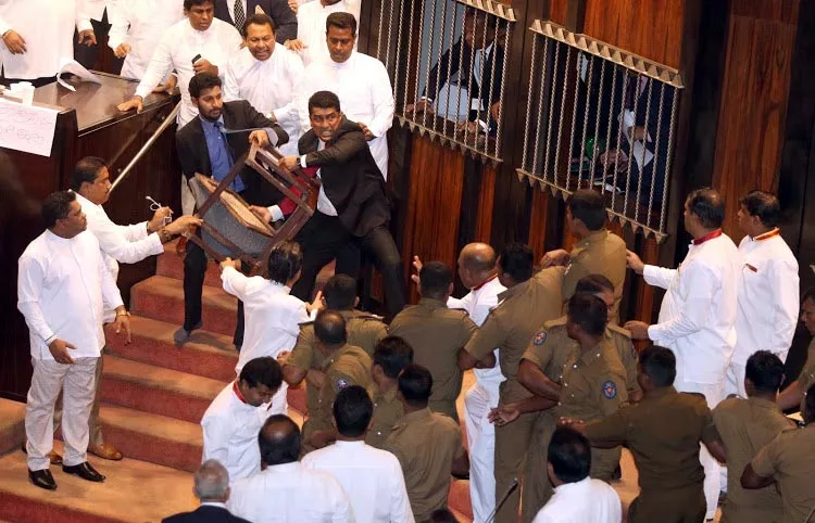 Chilli powder and chairs thrown in Sri Lanka parliament on second day - Sakshi